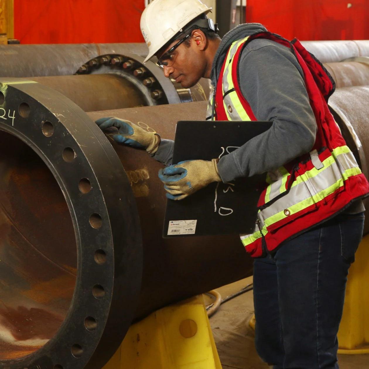 quality inspection of high-pressure oil and gas pipeline fitting by industrial safety engineer